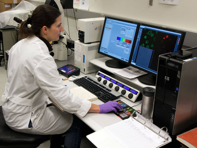 A woman working on a computer in a lab